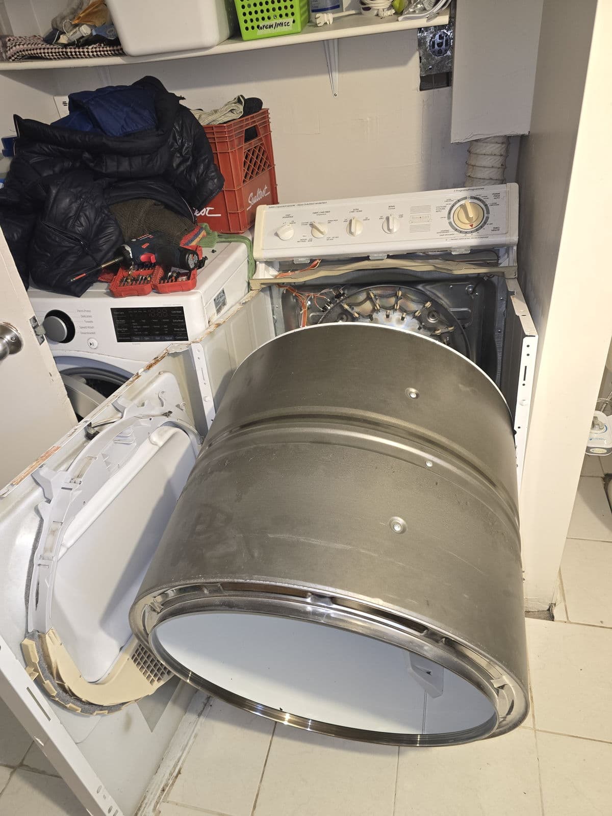 Dryer drum repair with tools on the washer