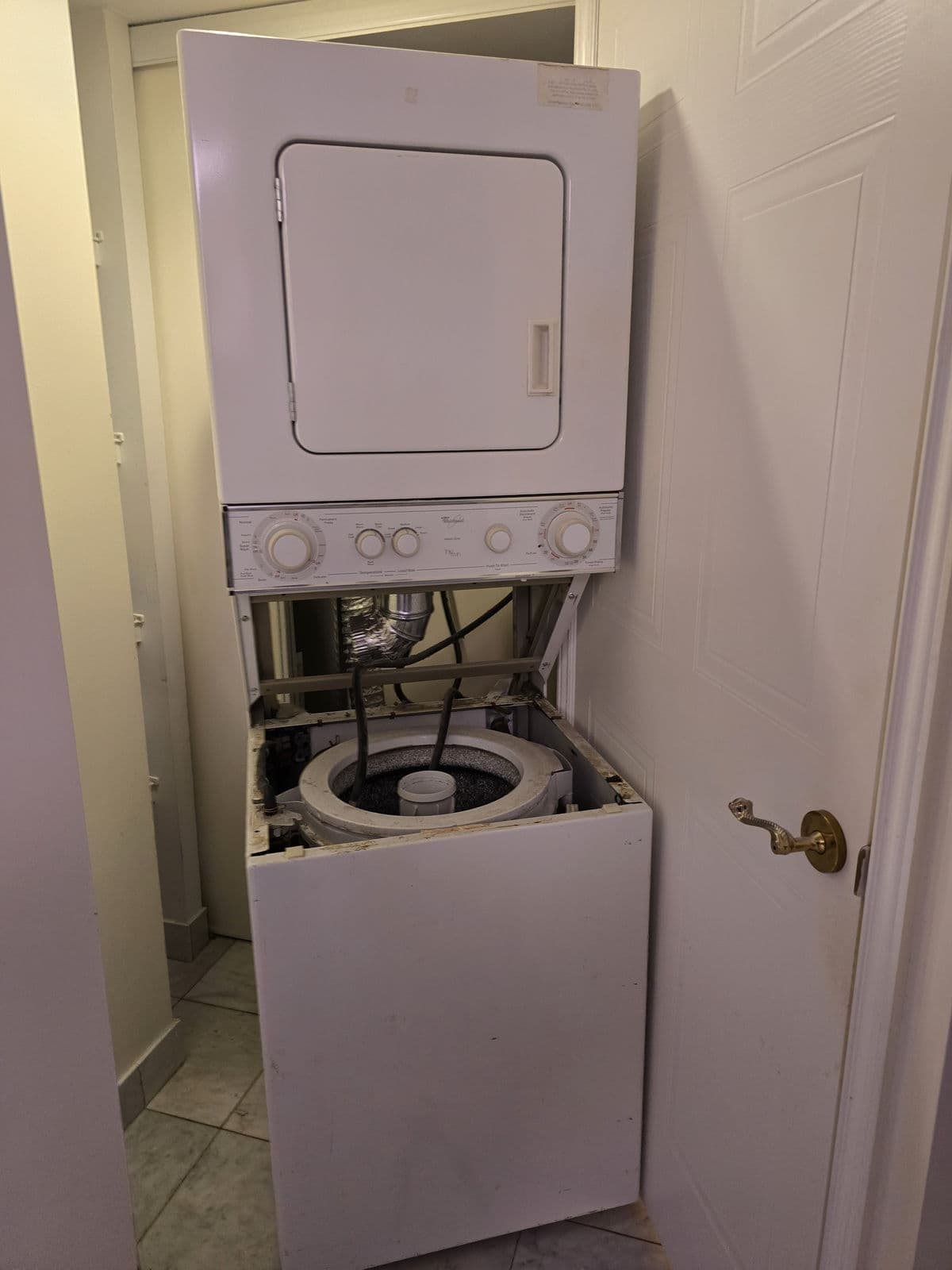 Stacked washer and dryer repair in an Ajax laundry closet