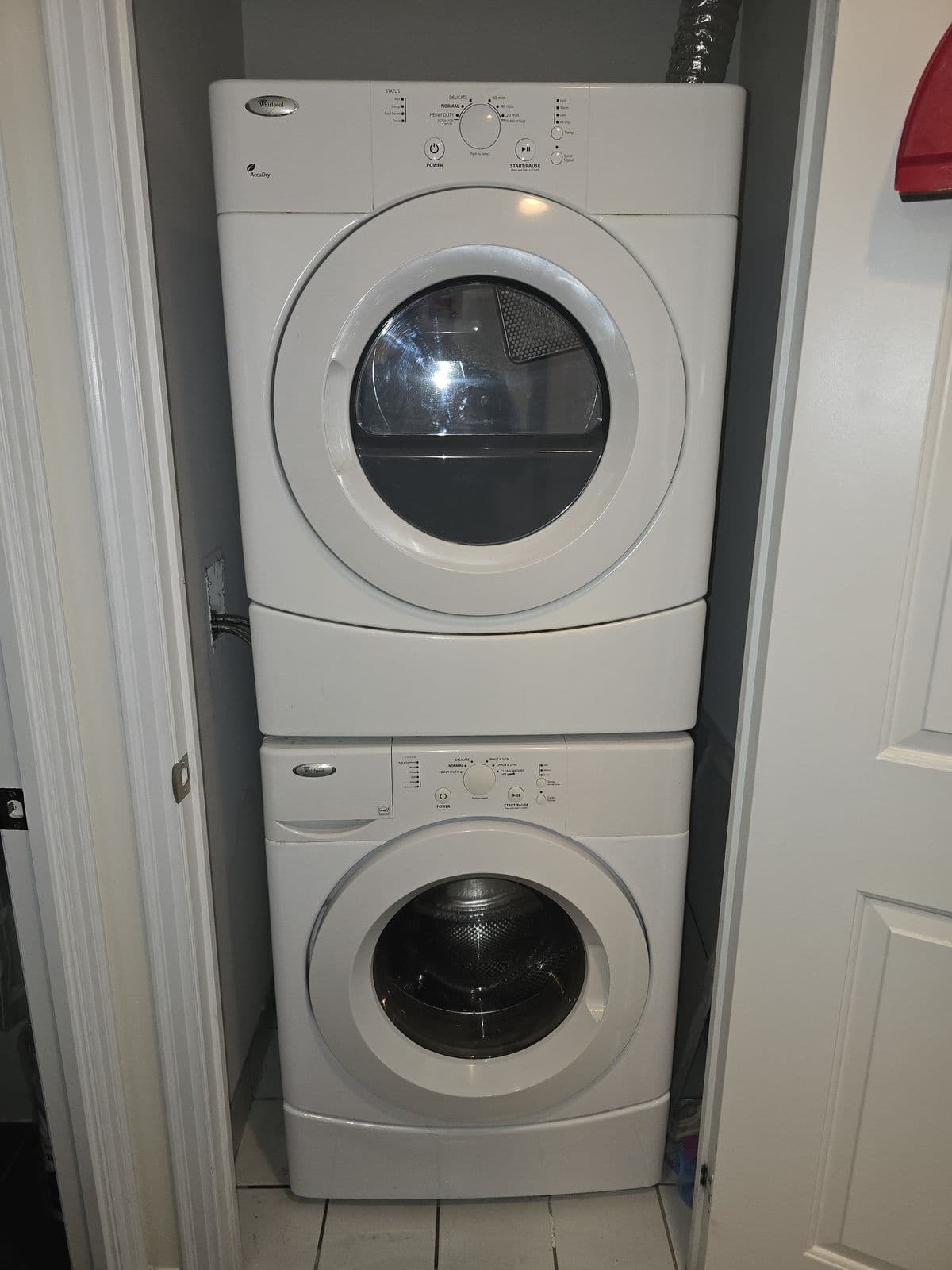 Stacked washer and dryer in a condo laundry closet